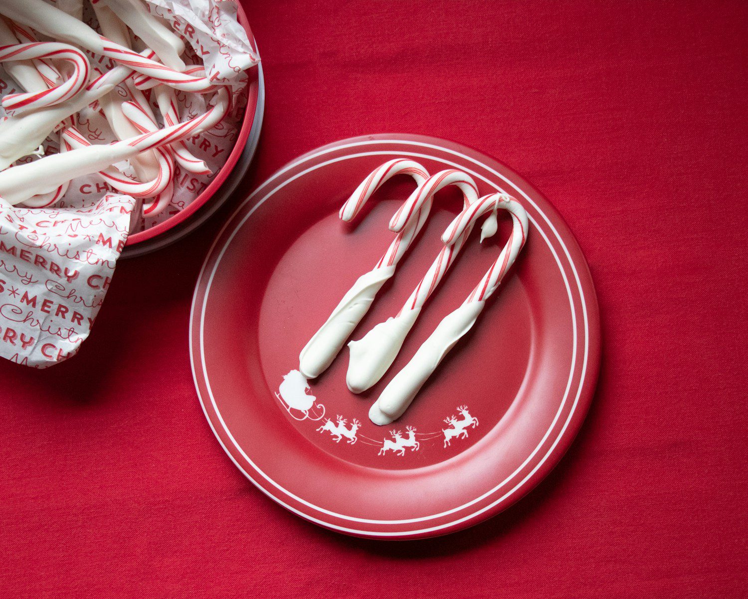 white and red candy canes on red plate
