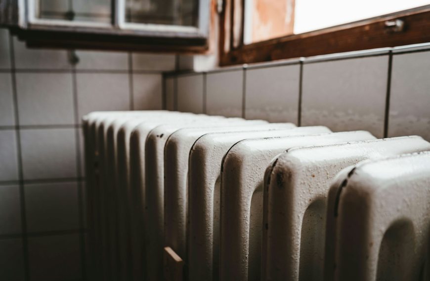 white radiator heater beside brown wooden window