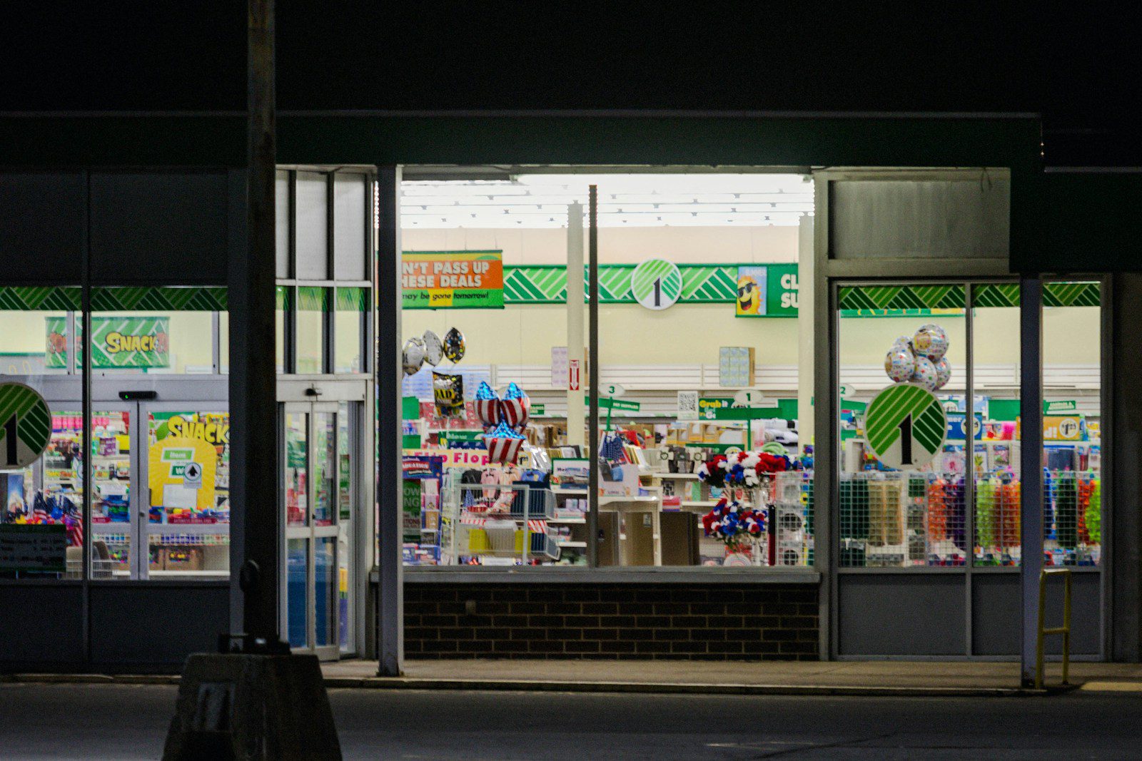 a store front at night with the lights on