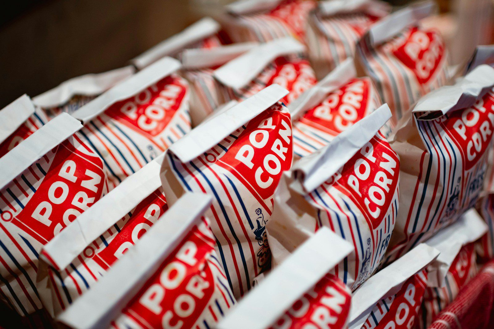 A bunch of red and white bags of popcorn