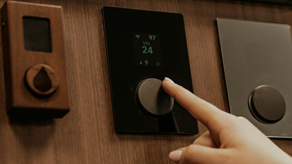 a hand holding a black device