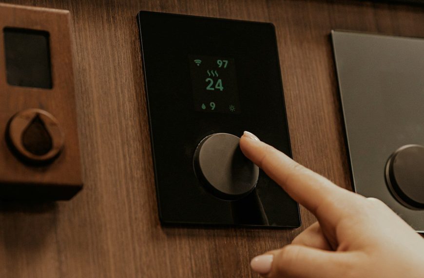 a hand holding a black device