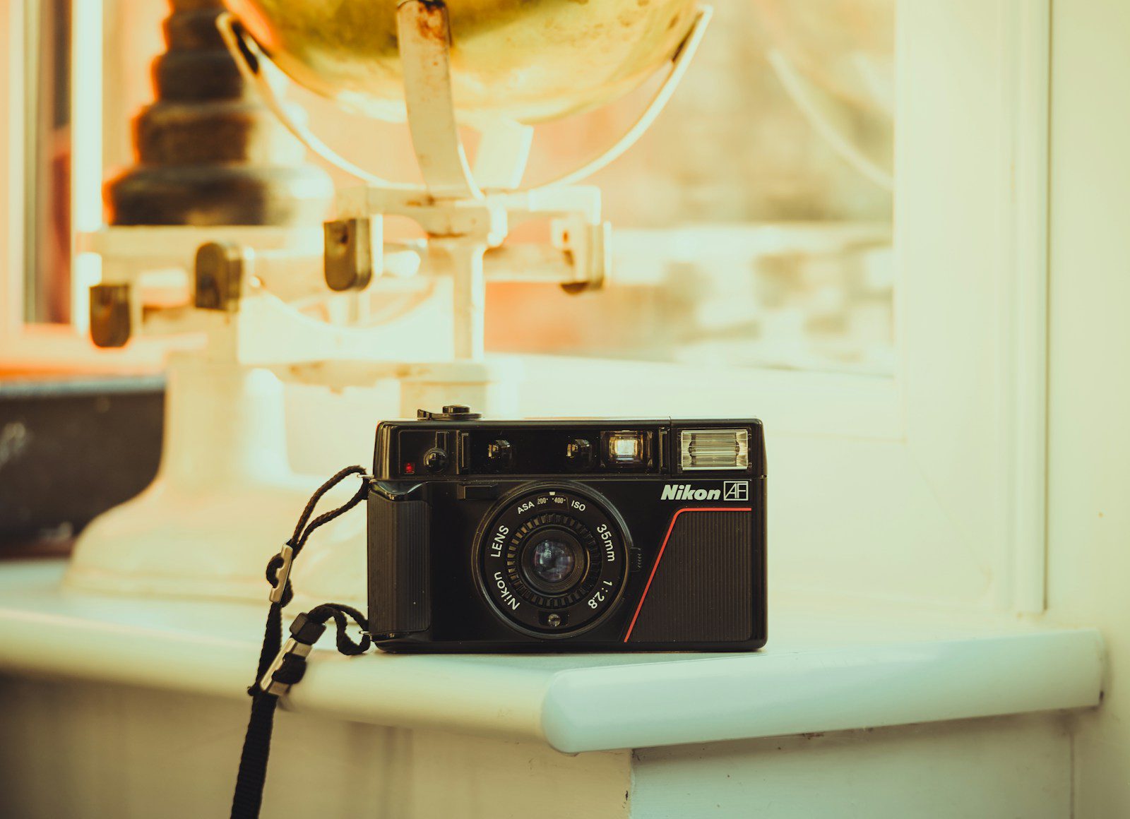 A camera sitting on top of a counter next to a window