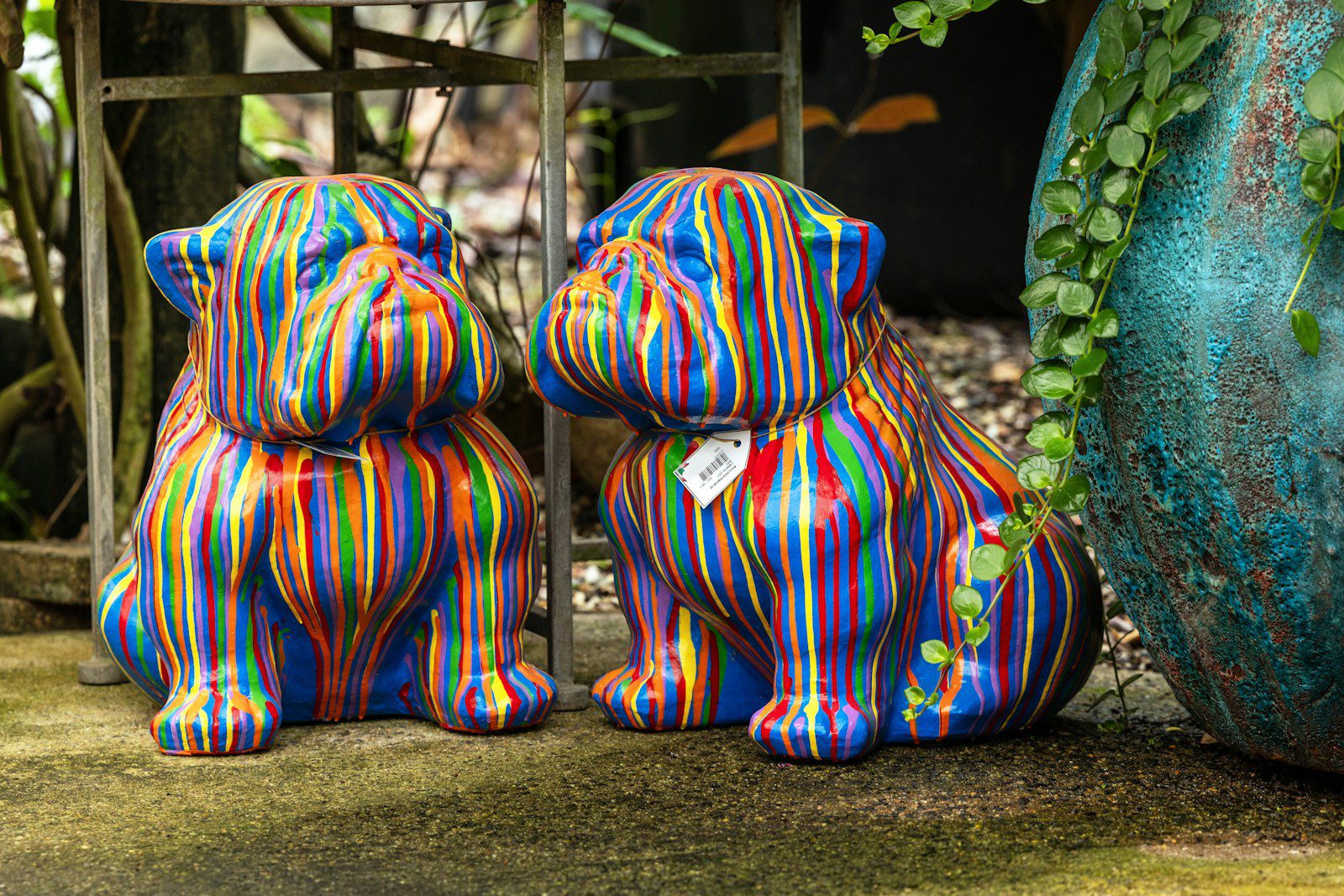 Colorful bulldog statues are showcased outdoors.