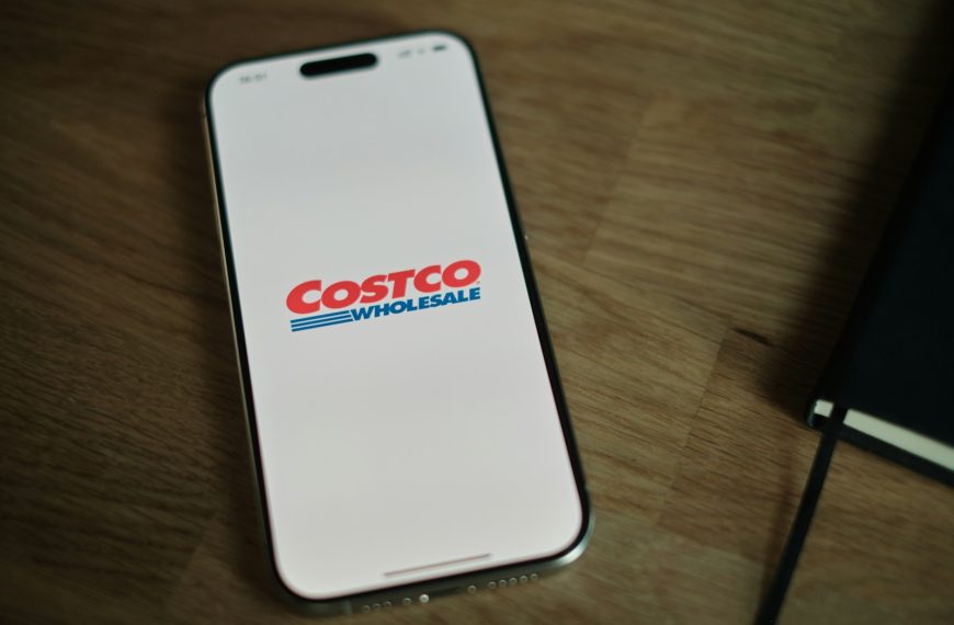 A white cell phone sitting on top of a wooden table