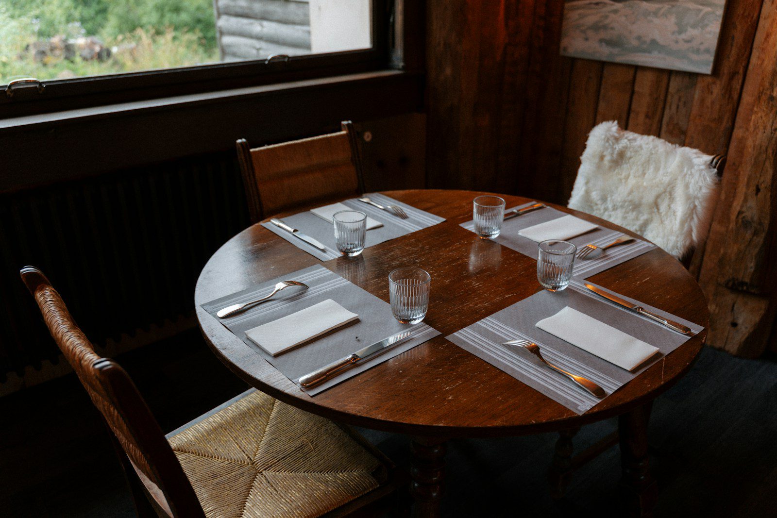 Round wooden table set for four people.