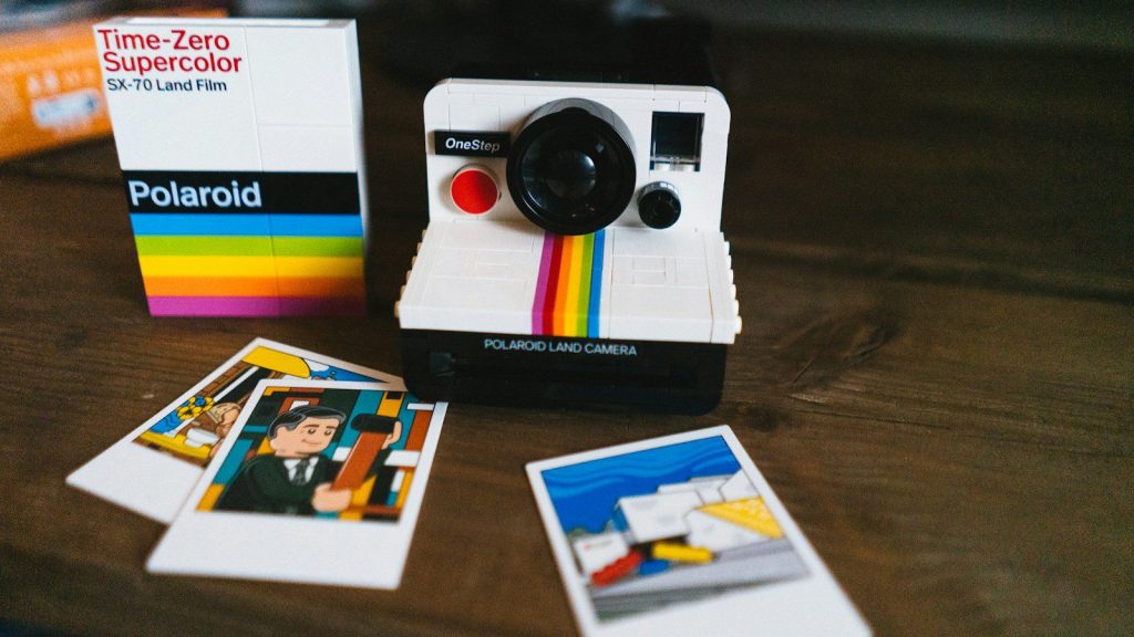 a polaroid camera sitting on top of a wooden table