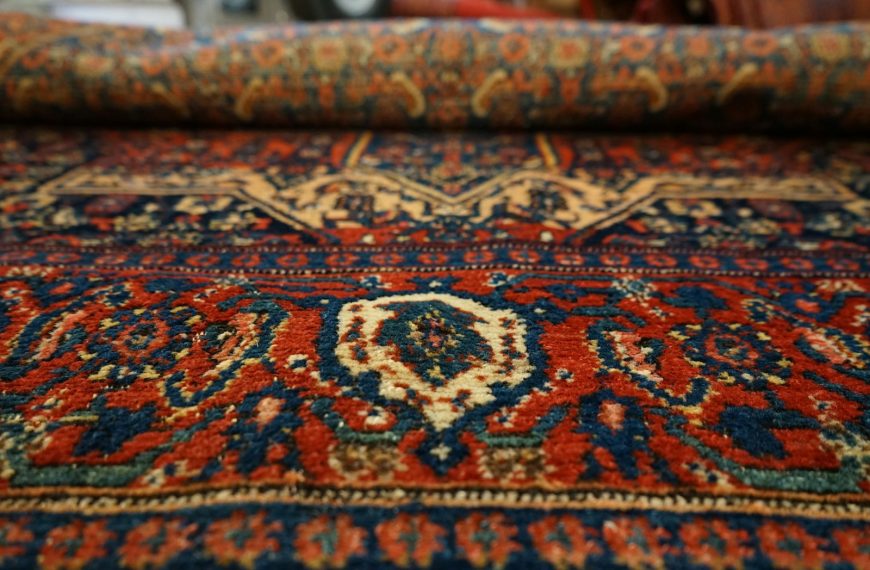 a close up of an oriental rug with a blue, red, yellow, and