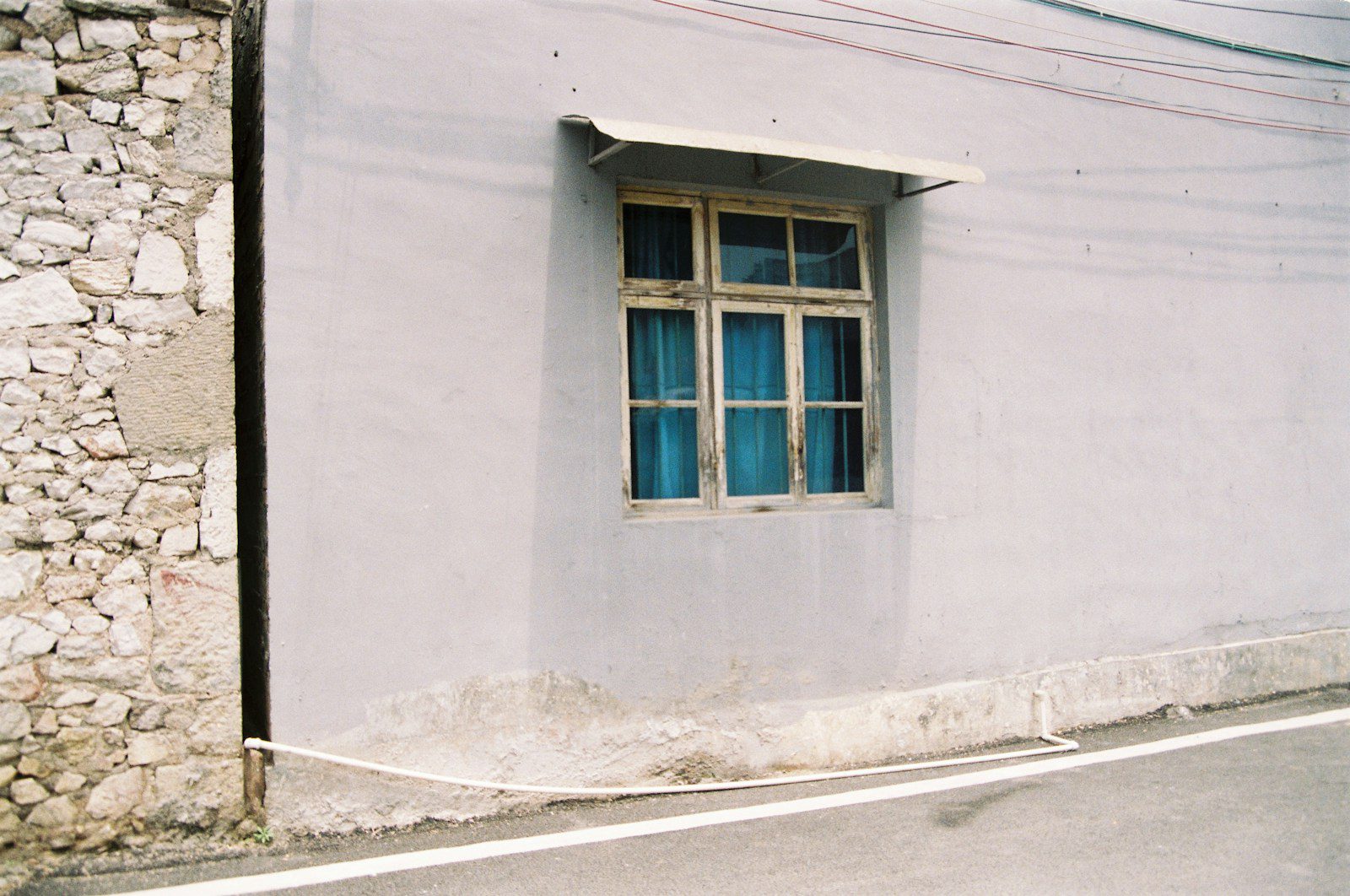 a white building with a blue window on the side of it