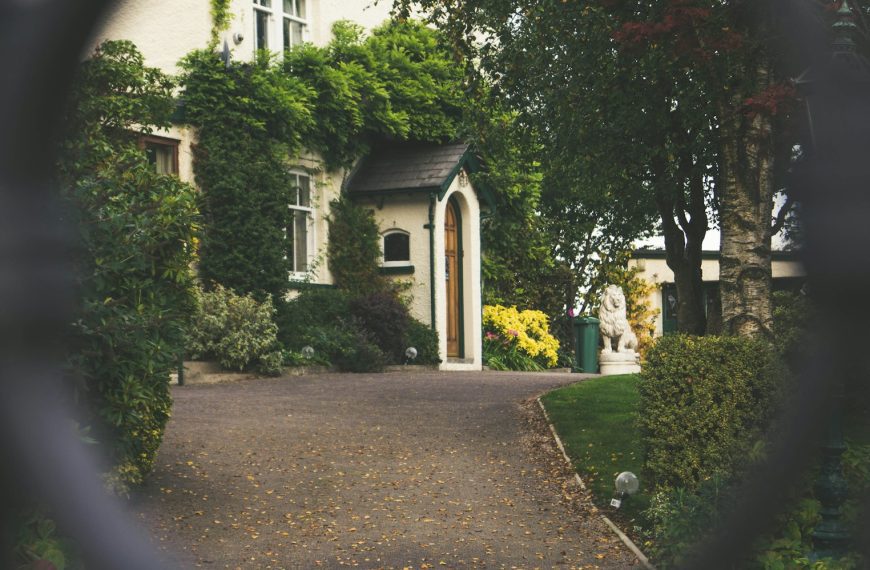 minimalist photography of house shot in front of chain fence
