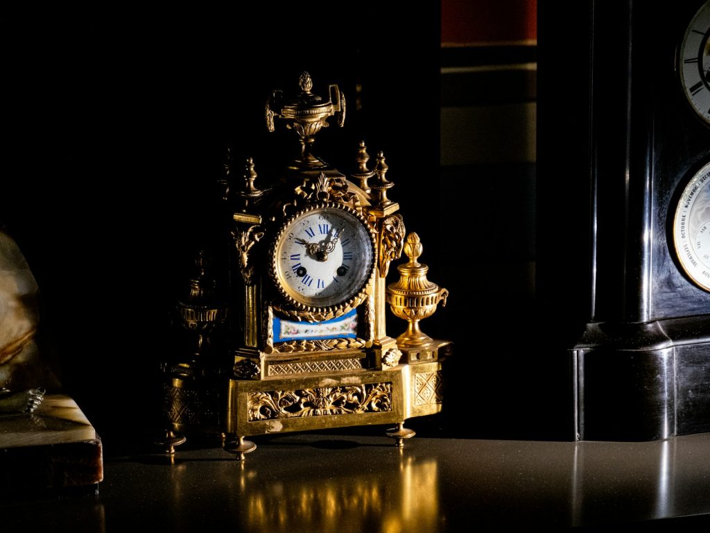 A couple of clocks sitting on top of a table