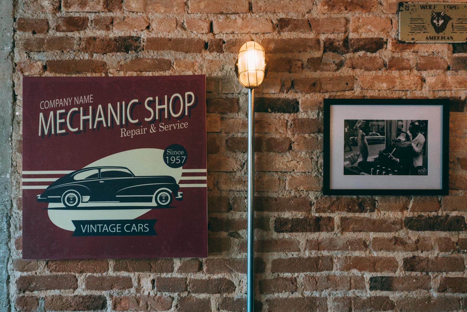 Brick wall with vintage mechanic shop sign and retro decor creating a nostalgic ambiance.