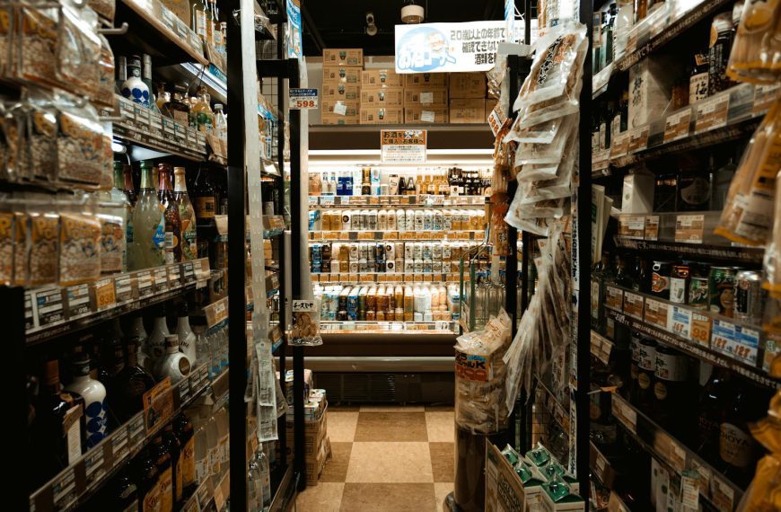 Explore a bustling Tokyo convenience store aisle packed with diverse products and merchandise.