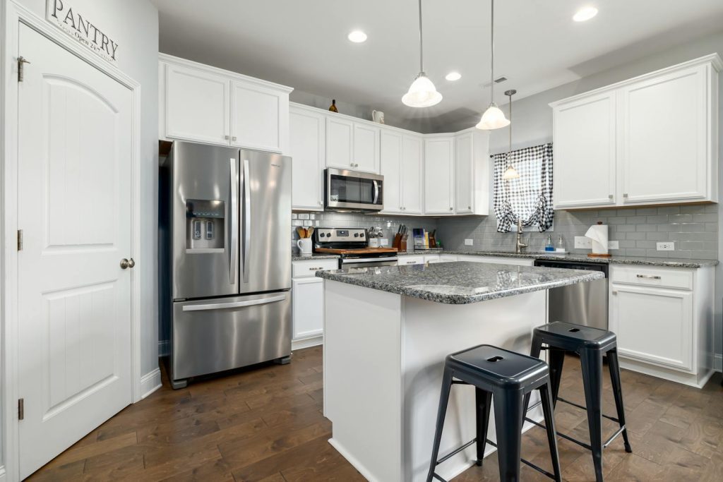 Sleek kitchen design featuring stainless steel appliances and white cabinetry.