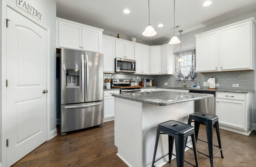 Sleek kitchen design featuring stainless steel appliances and white cabinetry.