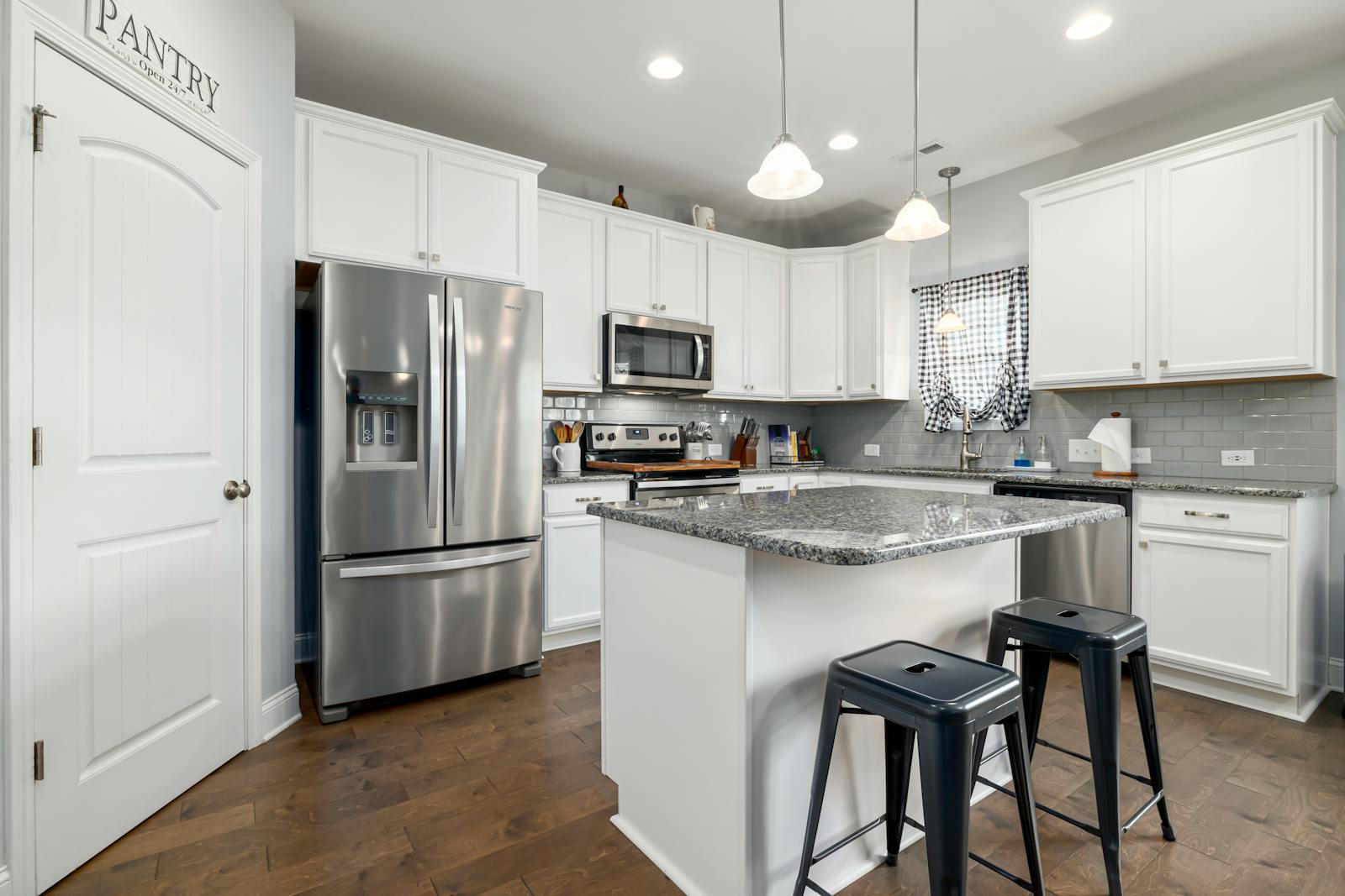 Sleek kitchen design featuring stainless steel appliances and white cabinetry.