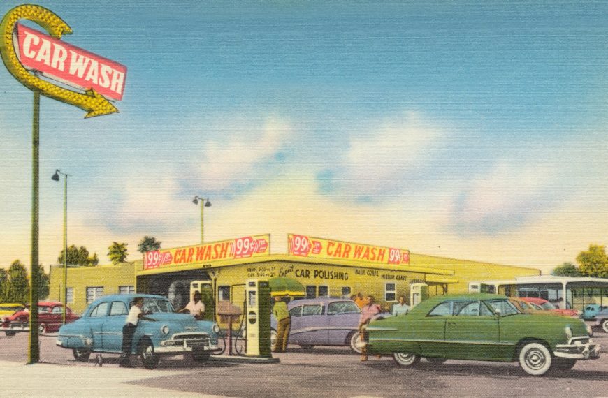 green car parked in front of store