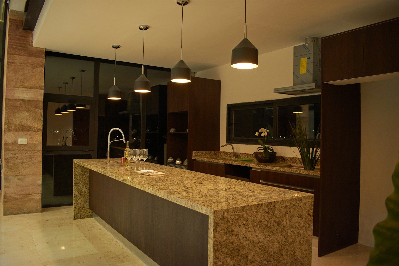 a large kitchen with a marble counter top