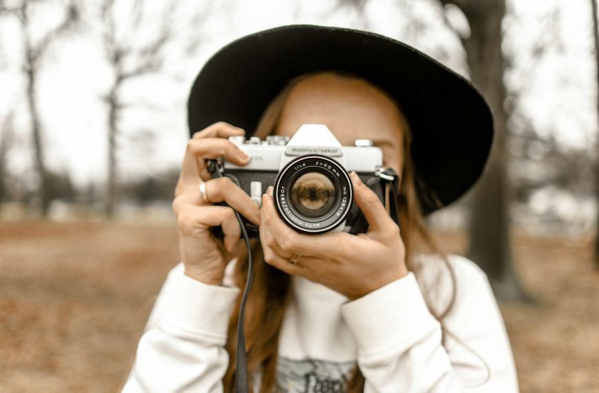 person holding camera taking picture to another camera