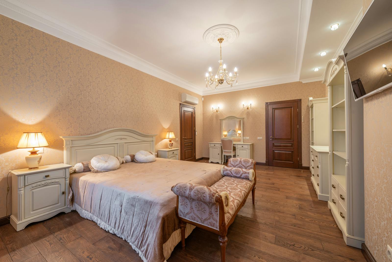 A roomy, elegant bedroom featuring vintage decor and soft lighting for a cozy atmosphere.