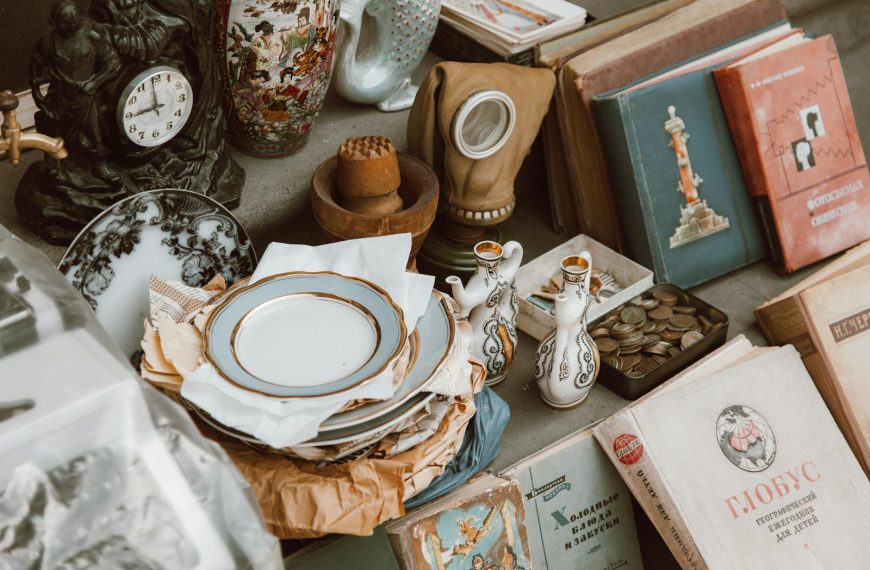 A collection of vintage books, ceramics, and antiques displayed in a nostalgic setting.
