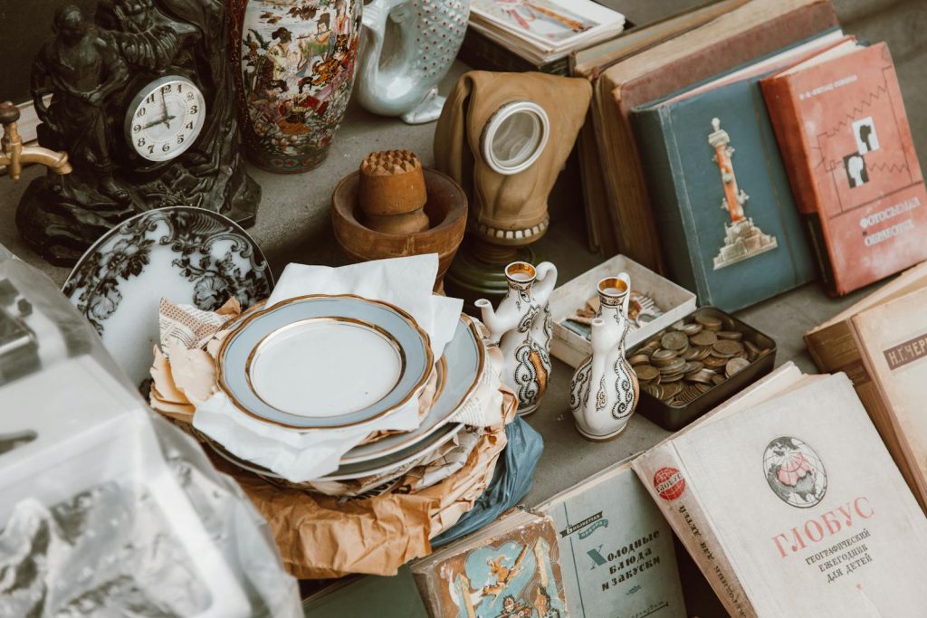 A collection of vintage books, ceramics, and antiques displayed in a nostalgic setting.