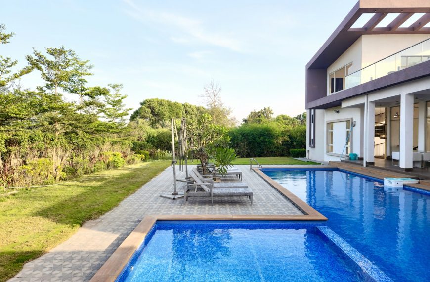 a large swimming pool next to a house