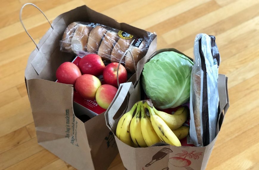 apples and bananas in brown cardboard box