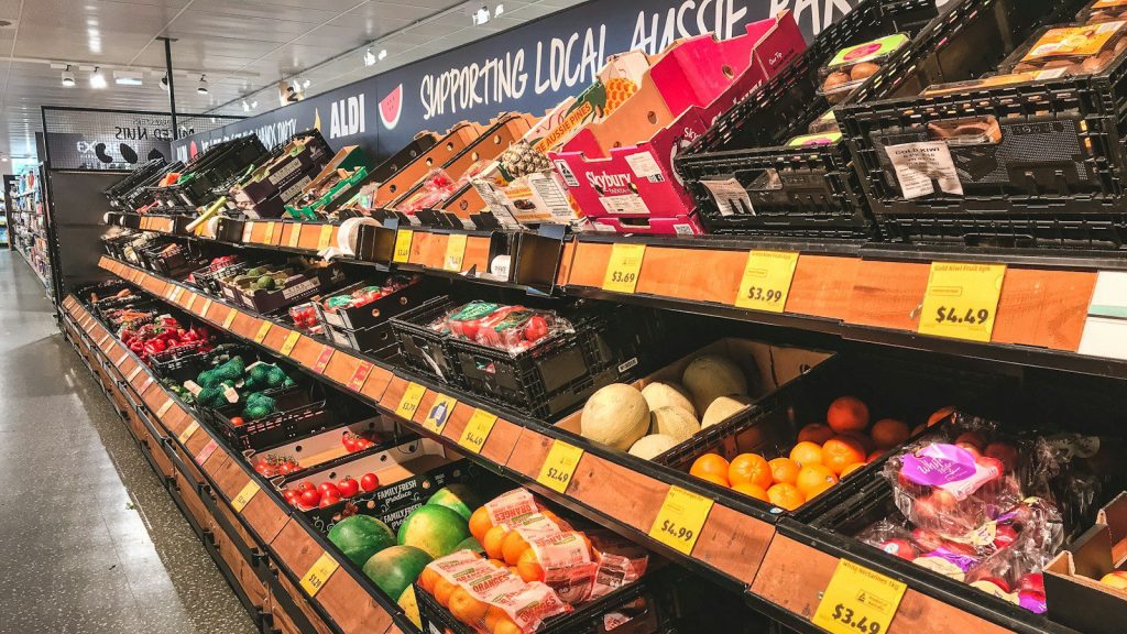 assorted fruits on brown wooden shelf