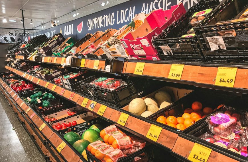 assorted fruits on brown wooden shelf