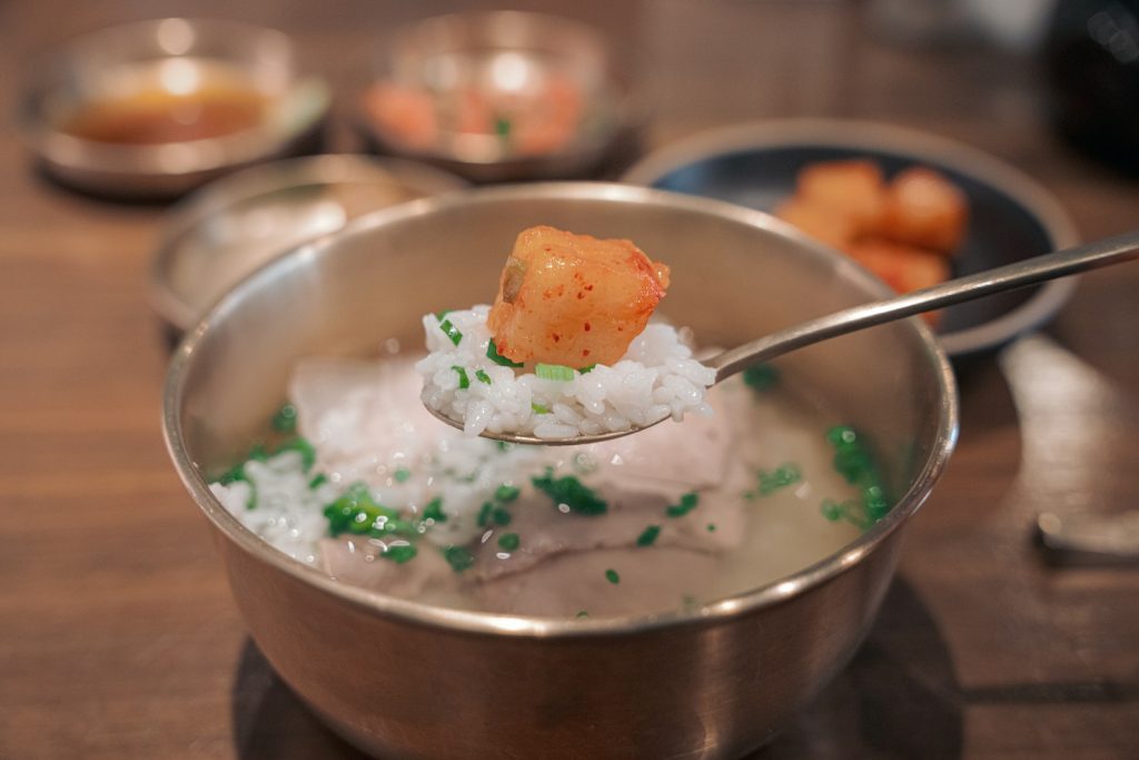 a spoon with some food in it on a table