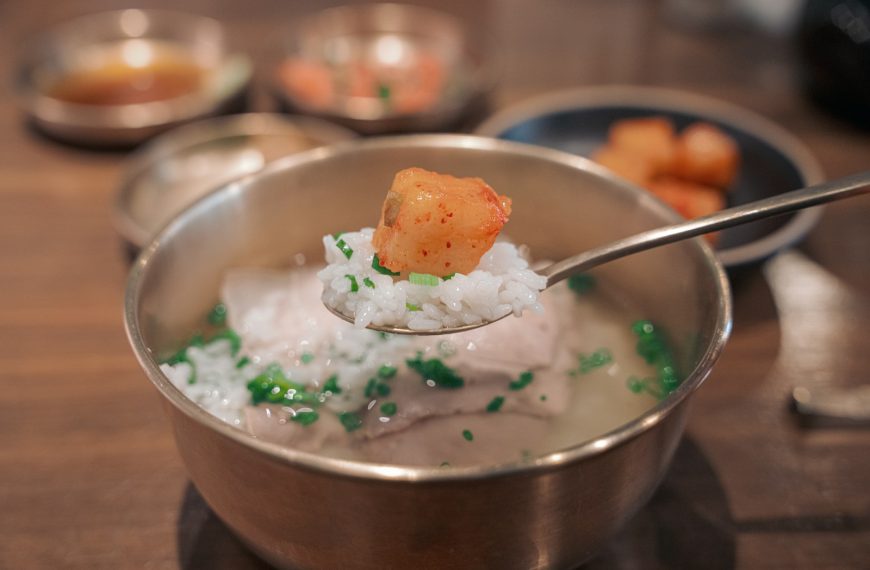 a spoon with some food in it on a table