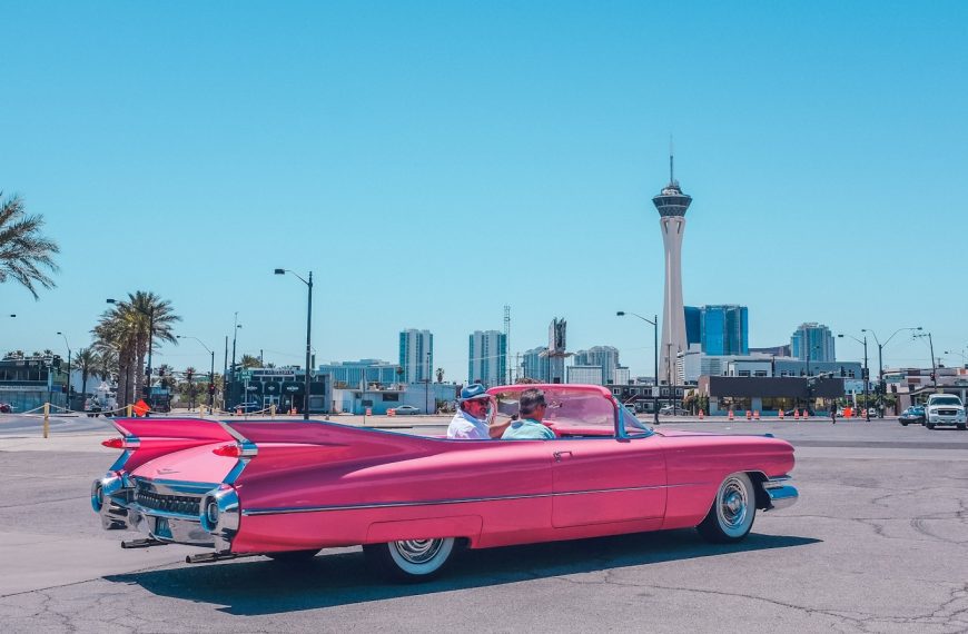 people riding pink car