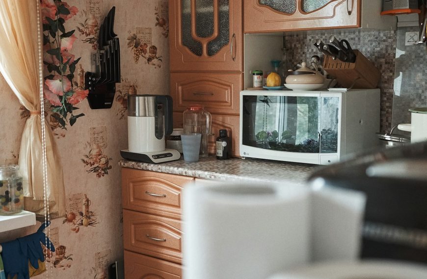 white microwave oven on brown wooden cabinet