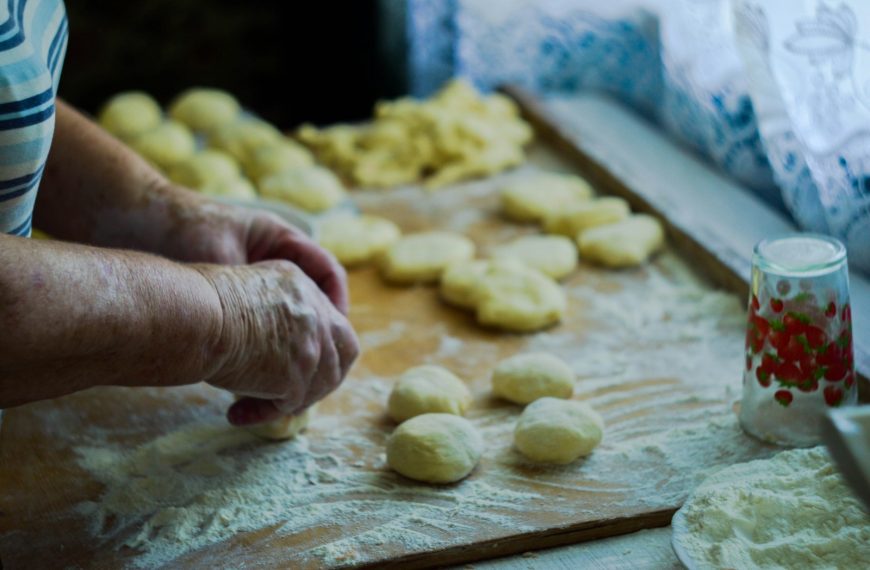 person making dough on brown wooden board