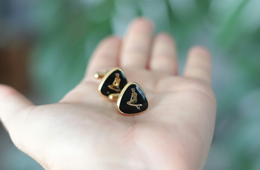 a person holding a pair of earrings in their hand