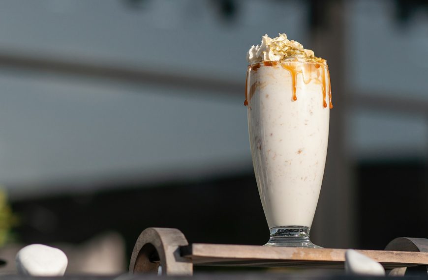 a glass of milk with a spoon