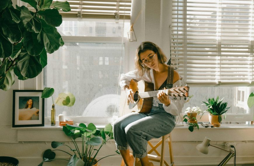 woman in white shirt and blue denim jeans sitting on chair