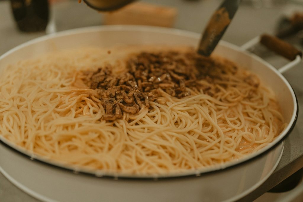A bowl of noodles with a spoon in it