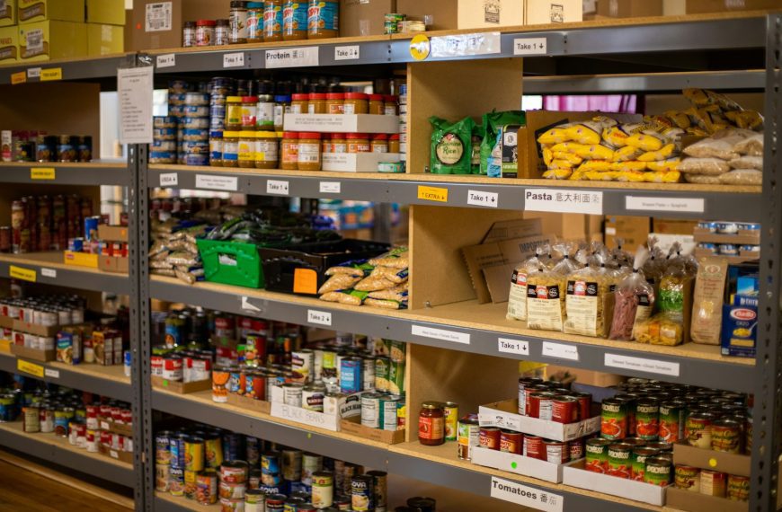 green and white labeled plastic bottle on brown wooden shelf