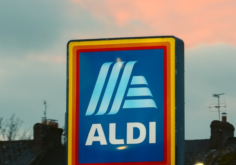 a blue and yellow aldi sign in front of a building