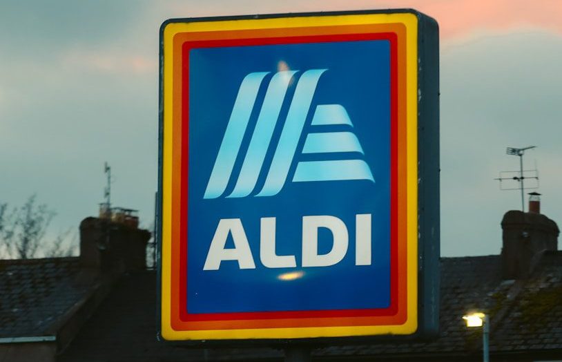 a blue and yellow aldi sign in front of a building