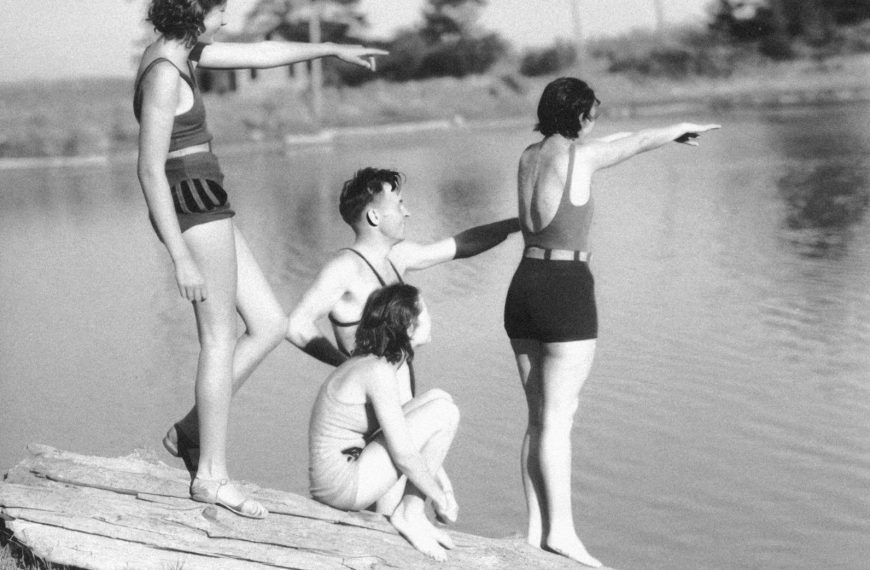 a black and white photo of a group of people on a dock