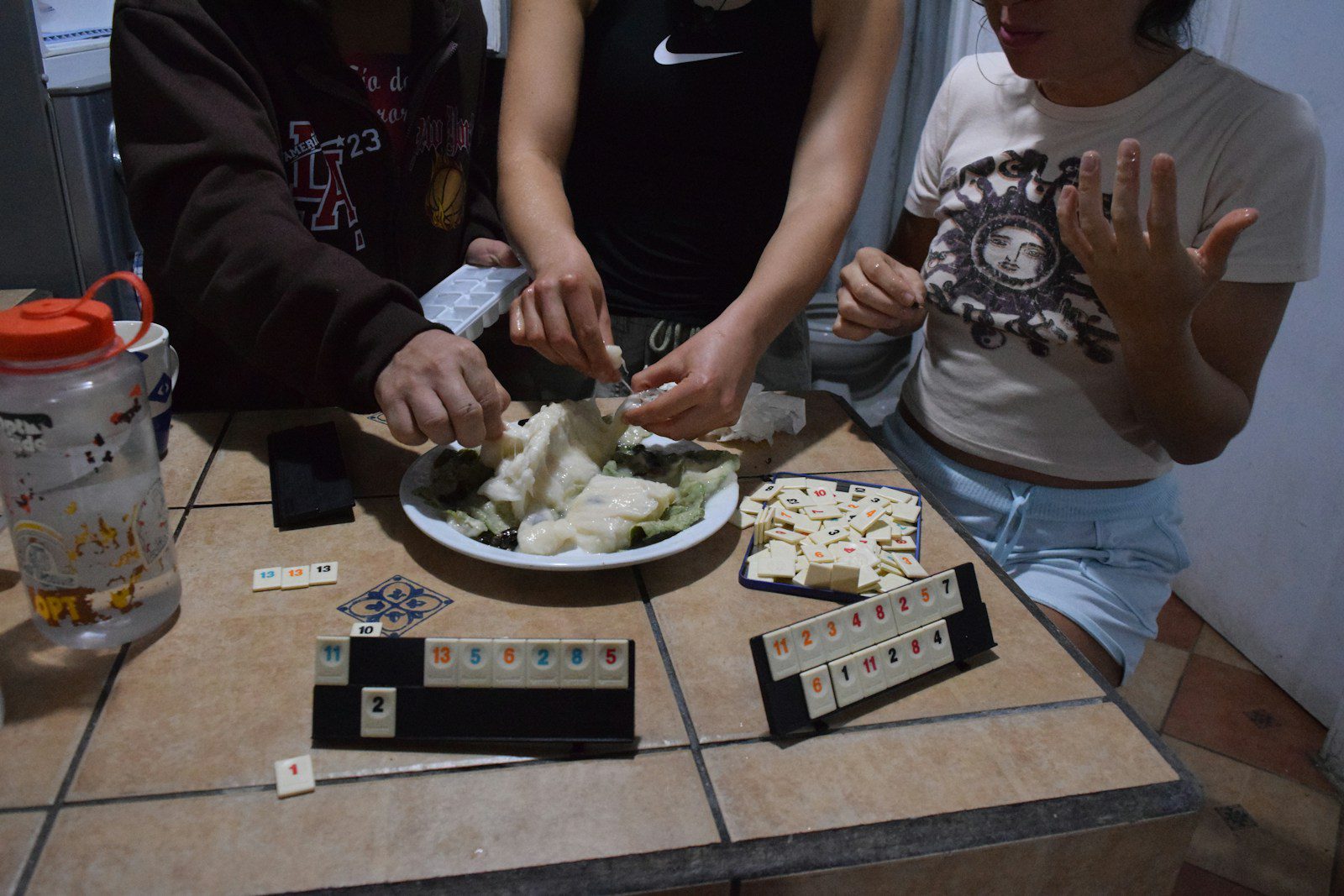 People play games and prepare food together.