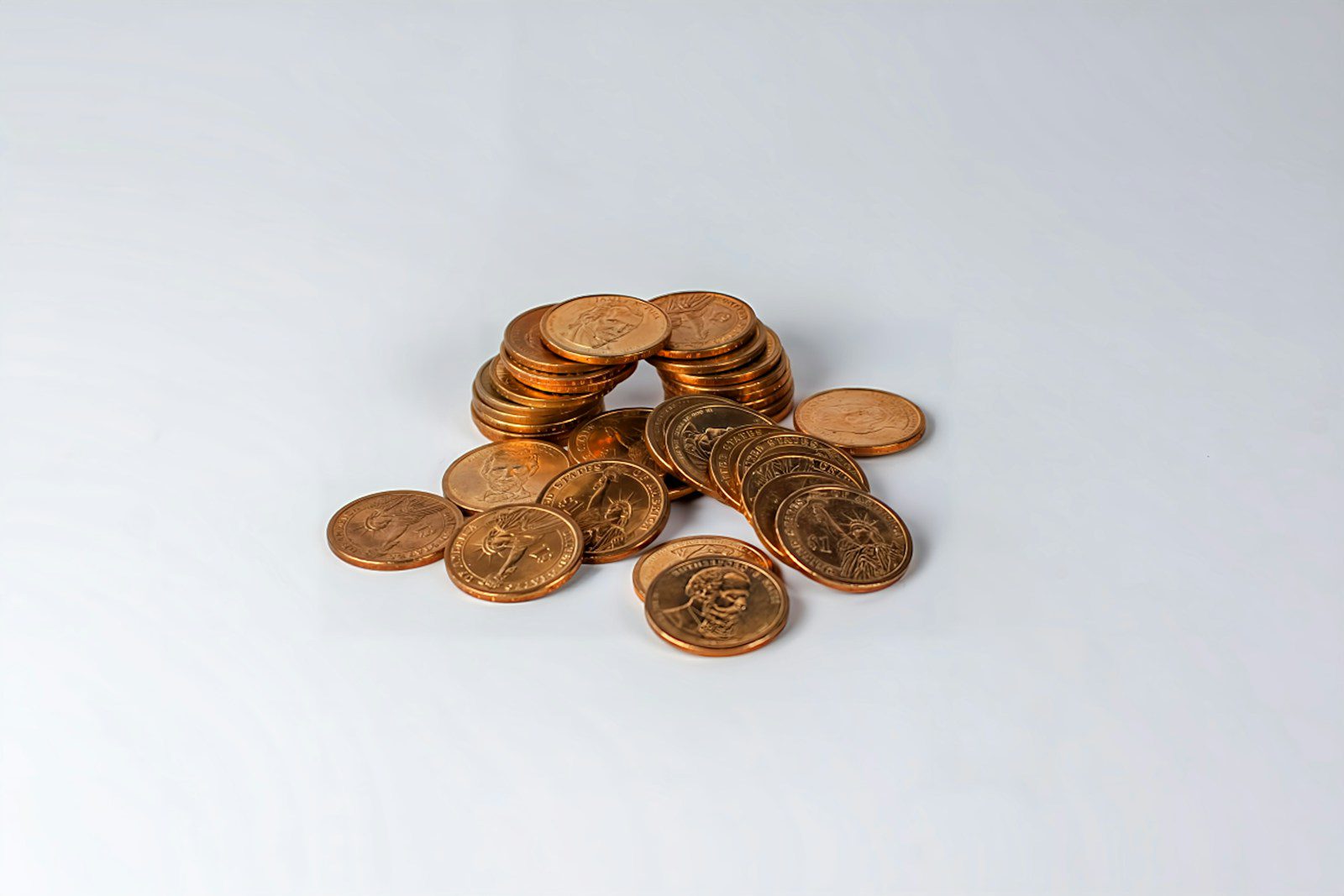 a pile of coins sitting on top of a white table