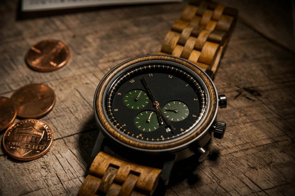 Close-up of a stylish wooden wristwatch on a rustic wooden table with coins.