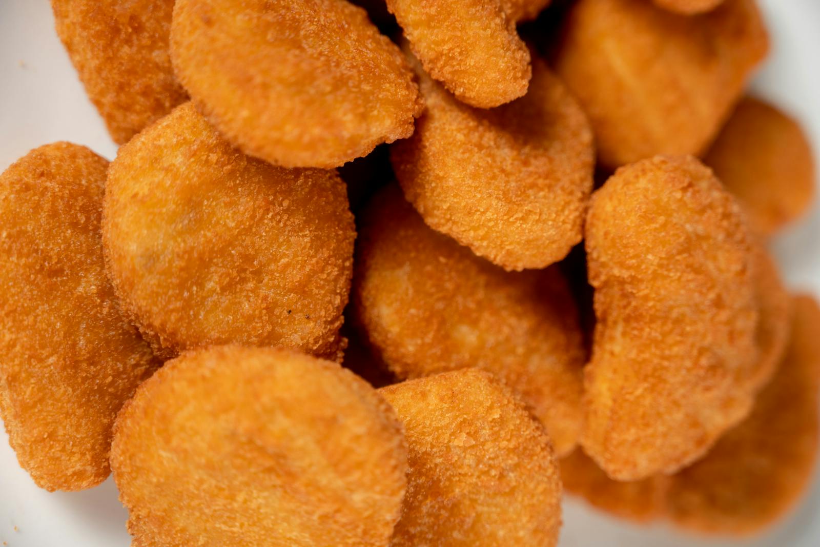 Golden crispy chicken nuggets perfectly breaded for a tasty treat.