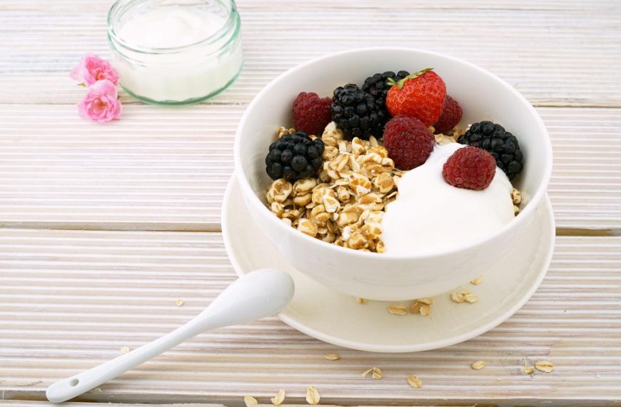 Delicious granola bowl topped with fresh berries and yogurt, perfect for a healthy breakfast.