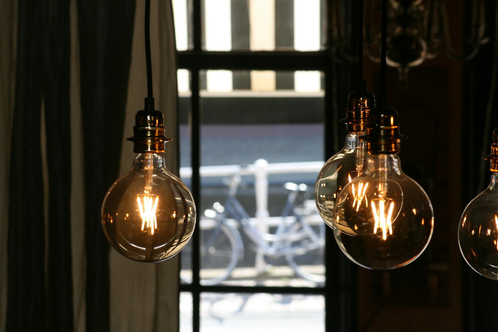 Close-up of vintage incandescent bulbs casting a warm glow in a cozy indoor setting.