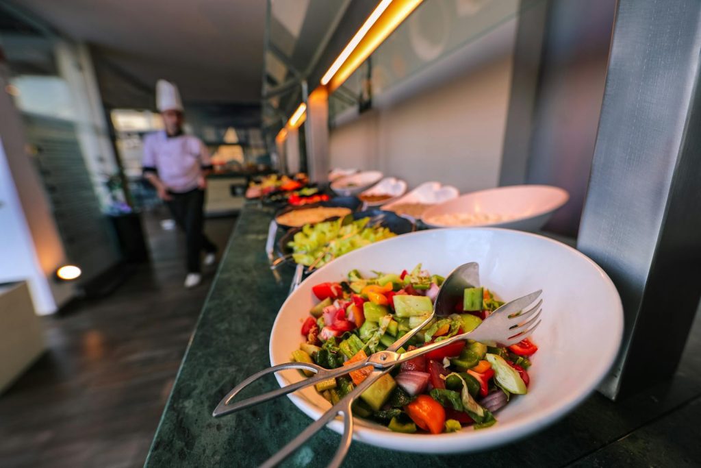 A colorful salad on a buffet table in a restaurant, emphasizing freshness and variety.